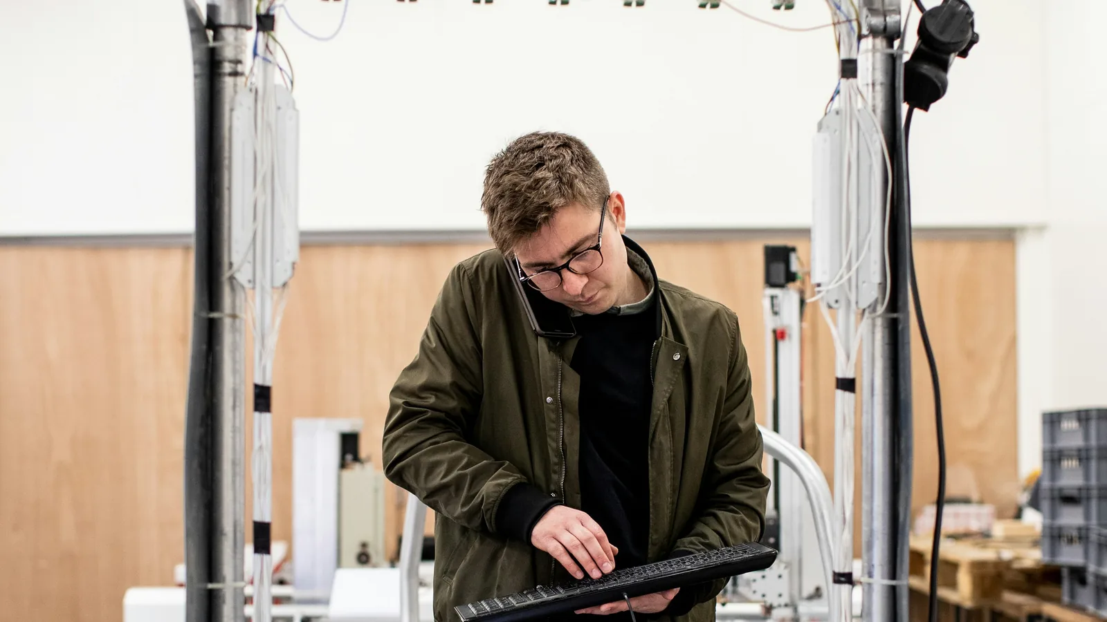 Technician testing a technology prototype in a research and development workshop.
