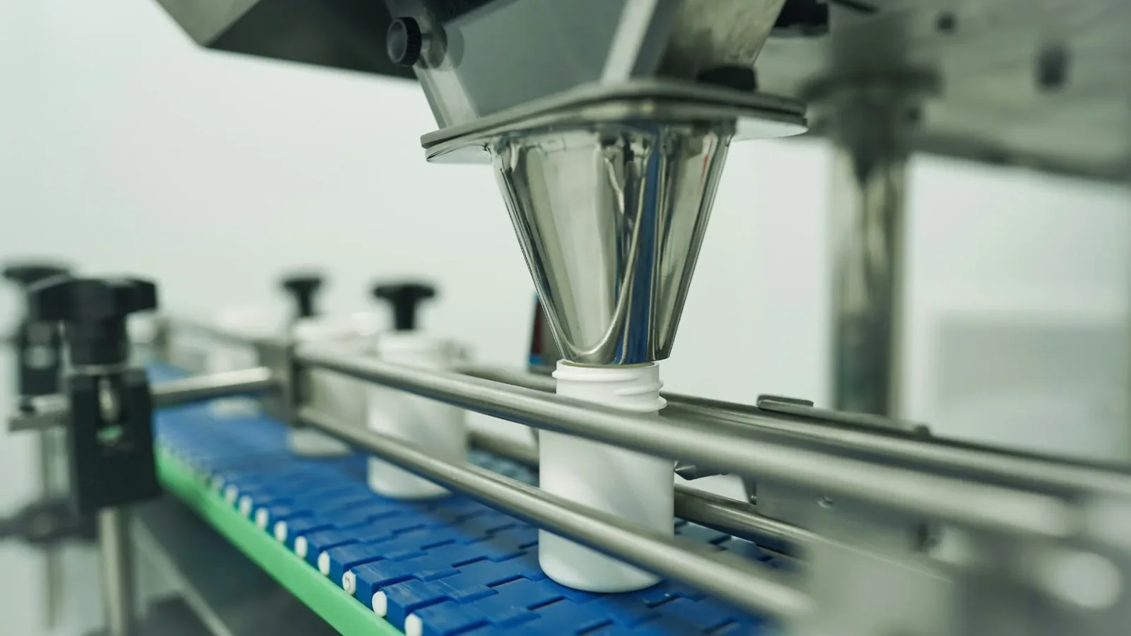Automated filling machine on an industrial production line.